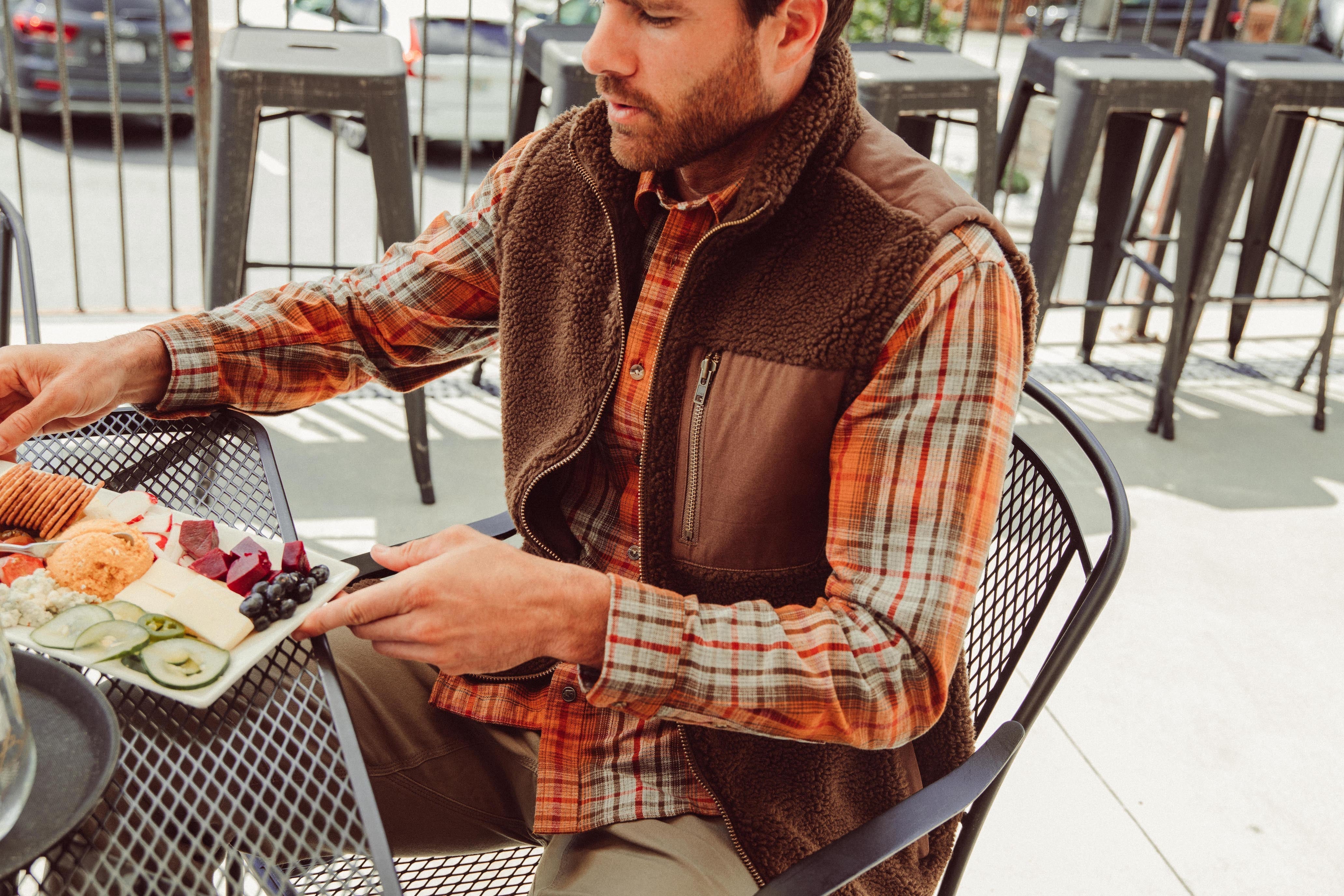 Man wearing Forge Vest eating outdoor