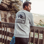 Man wearing Mountain Logo Crew standing outside