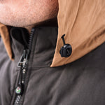 A man wears Pine Peak Down Vest standing in the snow