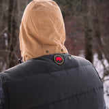 A man wears Pine Peak Down Vest standing in the snow