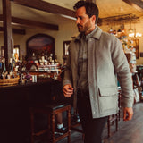 Man wearing Dover Wool Jacket and walking into a store