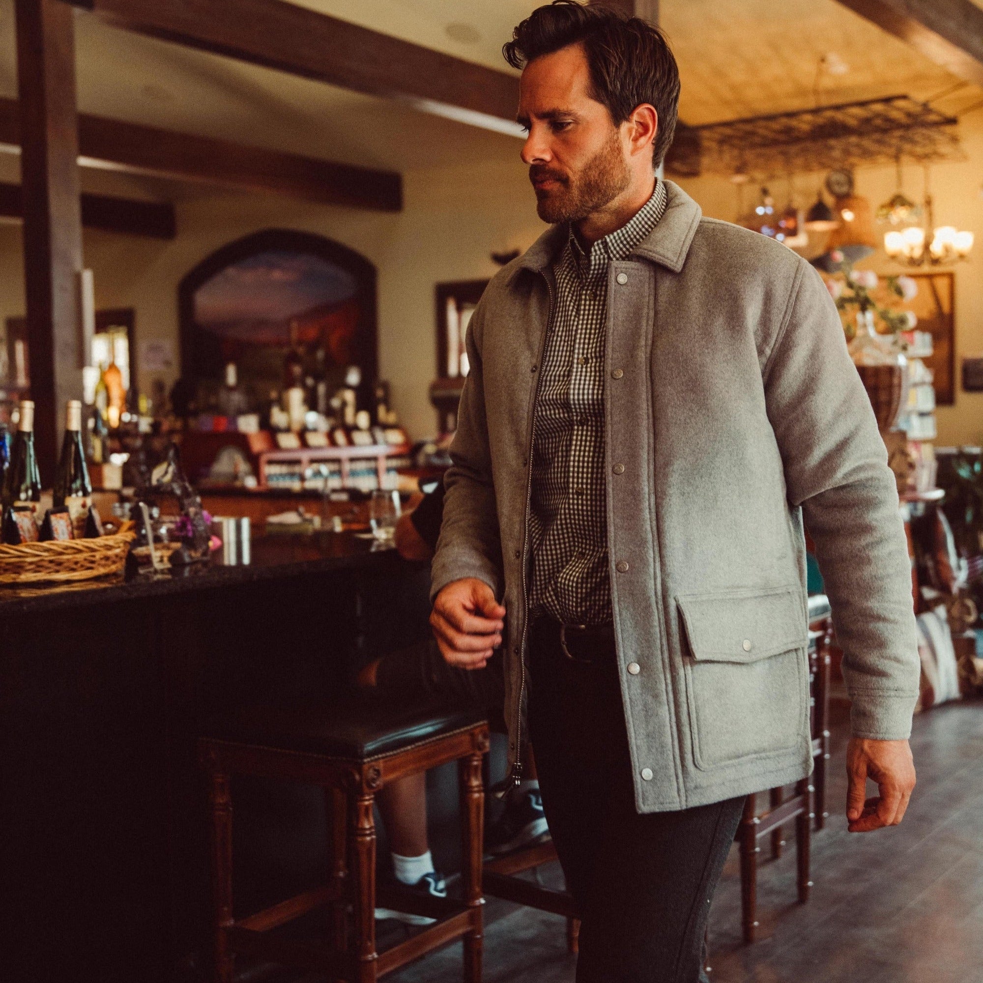 Man wearing Dover Wool Jacket and walking into a store