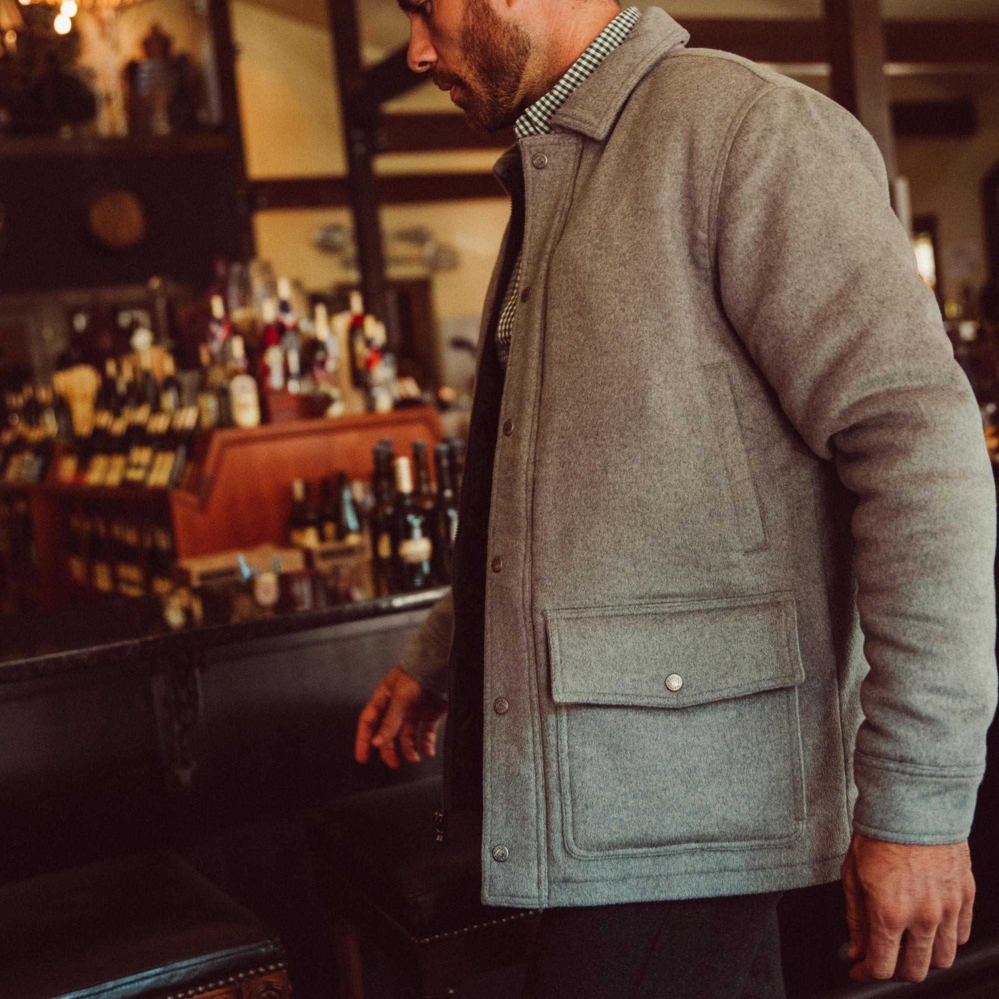 Man wearing Dover Wool Jacket and walking into a store