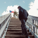 Man wearing Forge Jacket walking up the stairs