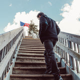 Man wearing Forge Jacket walking up the stairs