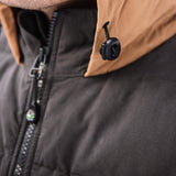 A man wears Pine Peak Down Vest standing in the snow