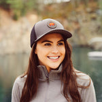 Unisex Bison Patch Trucker Hat worn by a woman