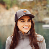 Unisex Bison Patch Trucker Hat worn by a woman