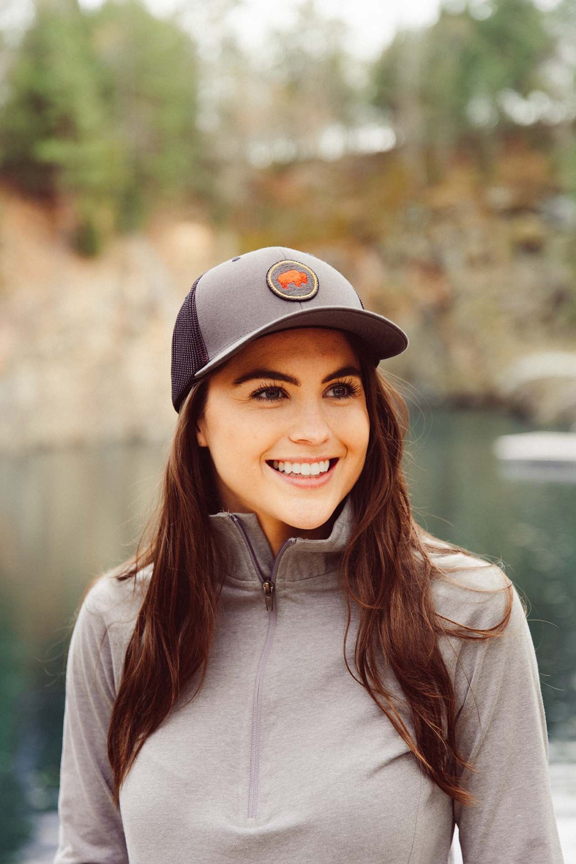 Unisex Bison Patch Trucker Hat worn by a woman