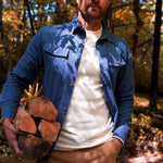 Man wearing Hamilton Chamois Shirt holding up the firewood