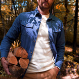 Man wearing Hamilton Chamois Shirt holding up the firewood