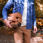 Man wearing Hamilton Chamois Shirt holding up the firewood