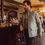 Man wearing Dover Wool Jacket and walking into a store