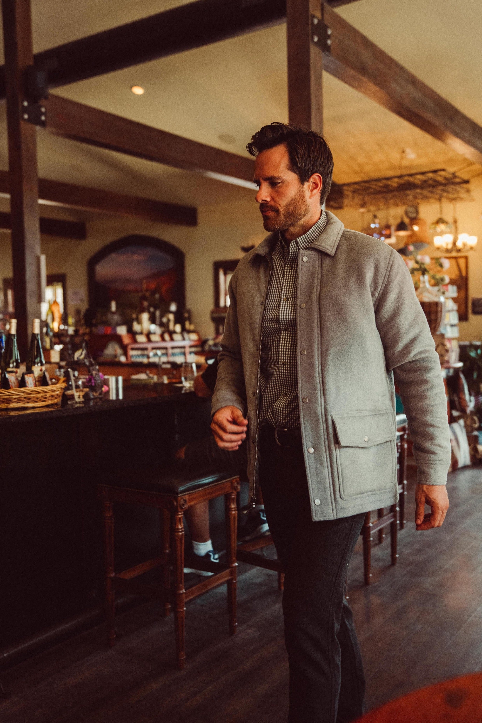 Man wearing Dover Wool Jacket and walking into a store