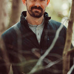 A man wears Trap Henley standing outdoor