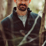 A man wears Trap Henley standing outdoor