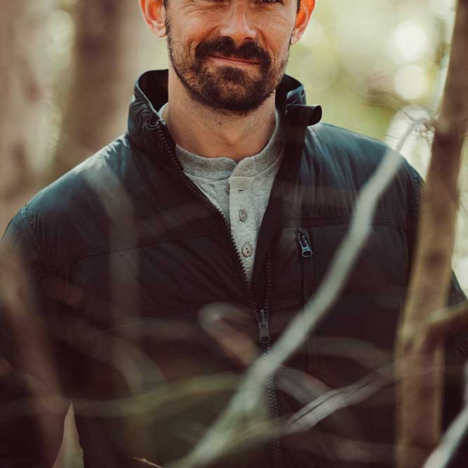 A man wears Trap Henley standing outdoor